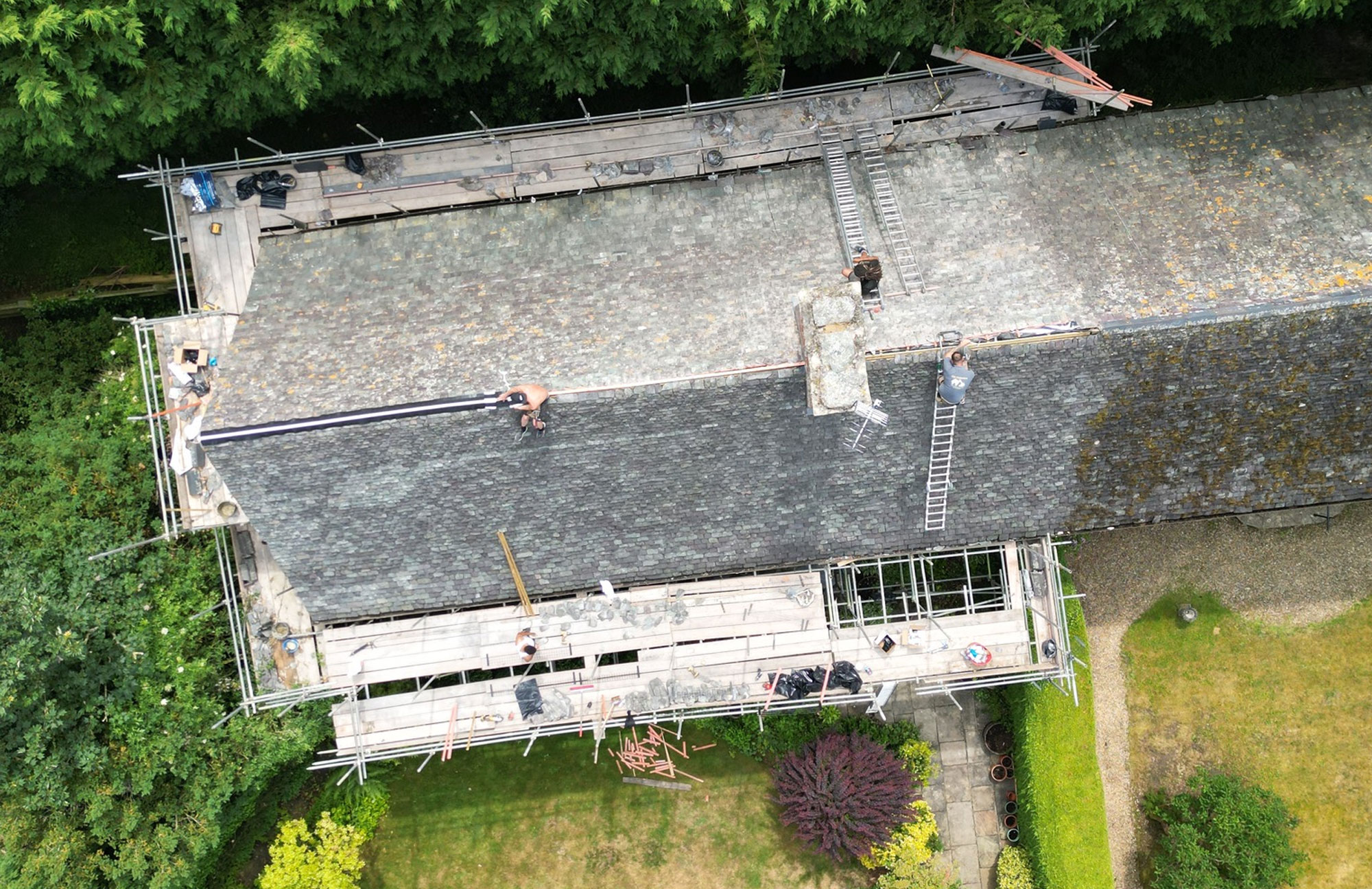 Aerial shot of men working on roof